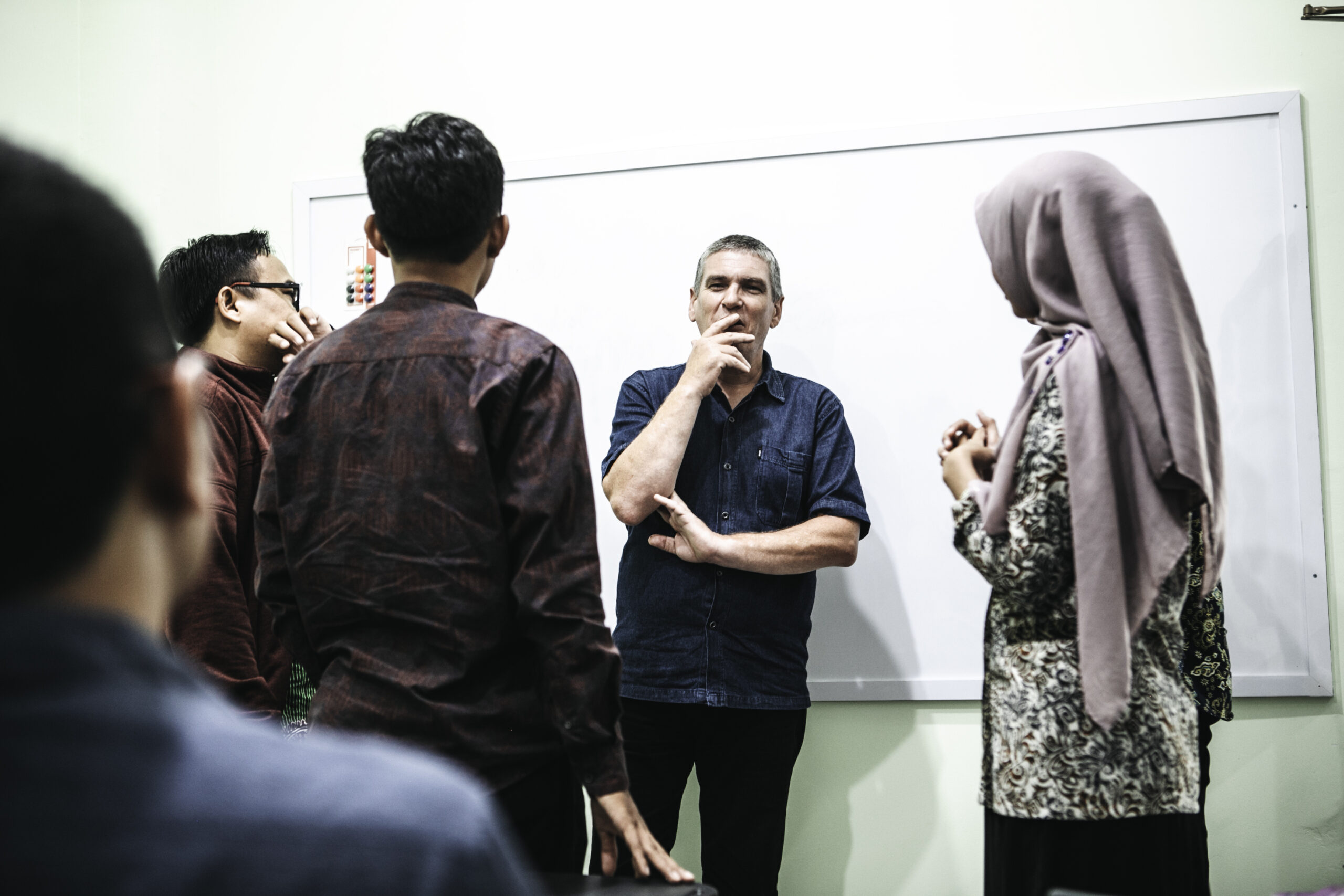 ECSC Trainer Teaching English to a Standing Group